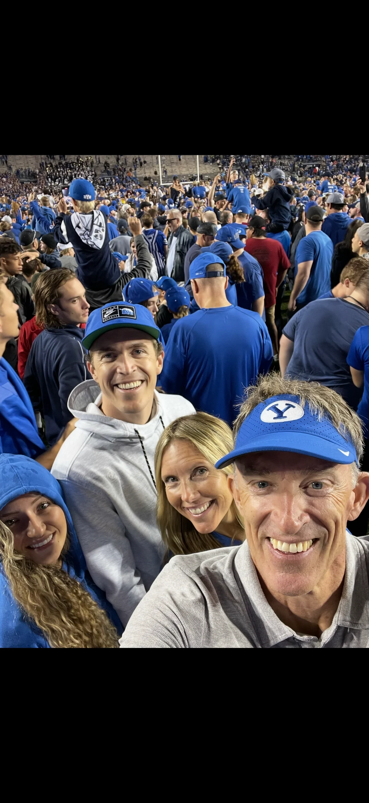 Abbey and me with my parents on the field at LaVell Edwards Stadium after BYU’s 2021 win over Utah.